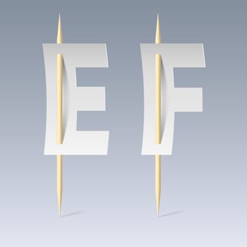 White paper cut font on toothpicks on grey background. E and F letters