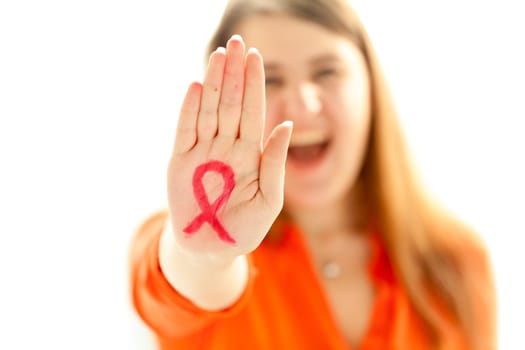 Portrait of young woman showing HIV red loop drawn on hand