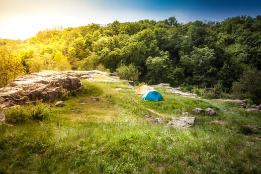 Beautiful landscape of tents on top of mountain at sunset