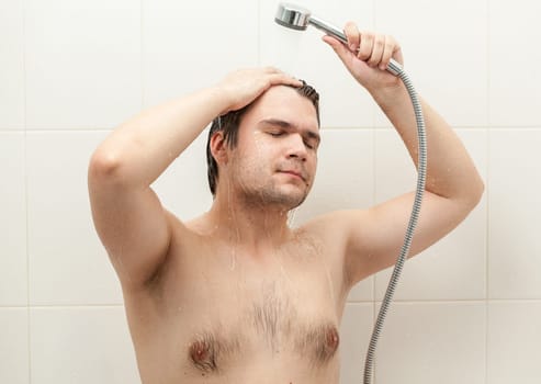 Closeup portrait of smiling man relaxing at douche
