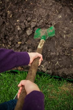 closeup photo of women hands digging soil with shovel