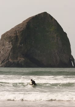 Vertical composition male surfer trying to catch a wave West Coast