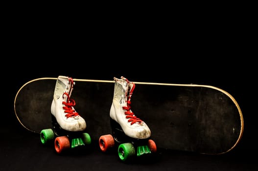 Vintage Style Black Skateboard and Skate Boot on a Dark Background