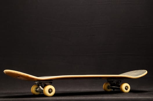 Vintage Style Black Skateboard on a black Background
