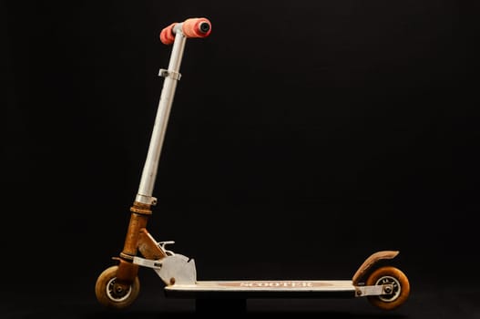 Metal scooter for child on white background