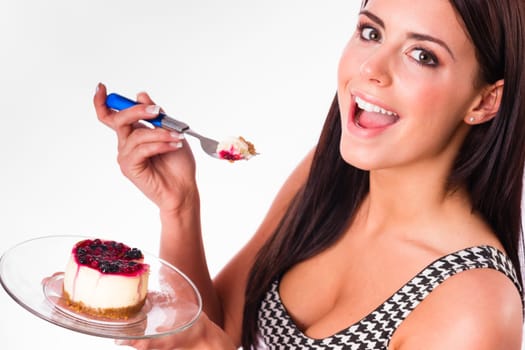 Beautiful woman smiles while eating cheesecake dessert