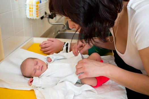 sleeping newborn baby in the hospital - the first hours of the new life, family looking to infant