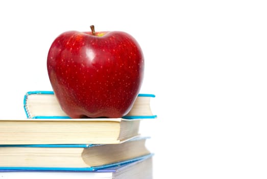 Red apple and stack of books for school