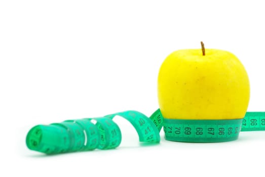 yellow apple and measuring tape on white