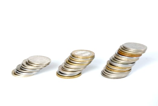 three towers of coins isolated on a whiteness