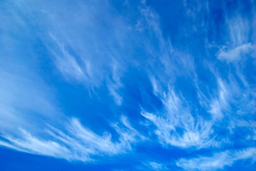 Blue sky background with tiny clouds