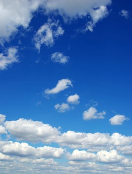Blue sky background with tiny clouds