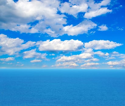 cloudy blue sky above a surface of the sea