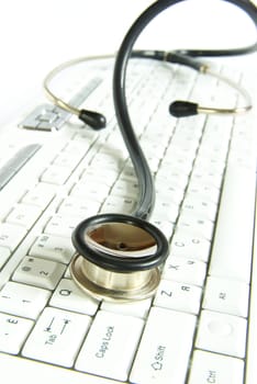 white computer keyboard with a stethoscope