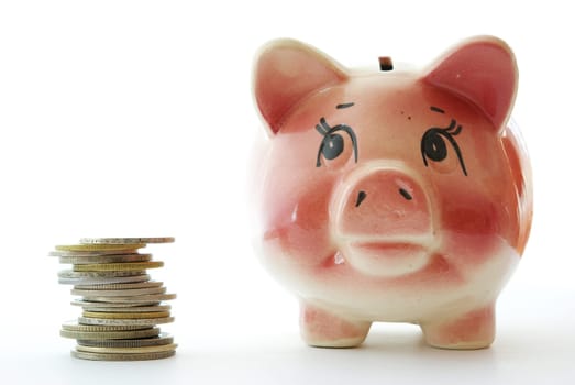 Pink piggy bank  isolated on white background with coins