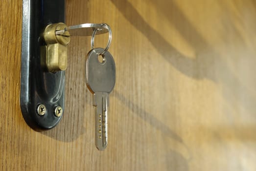 A hotel room door lock and key