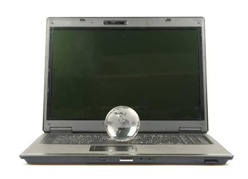 glass globe placed on a laptop isolated on white