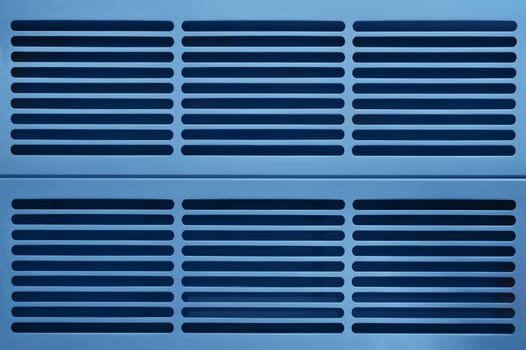 abstract industrial background made of aluminium ventilation grilles in blue light