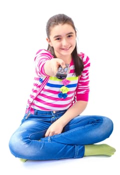 Little girl with remote control laying down and watching tv