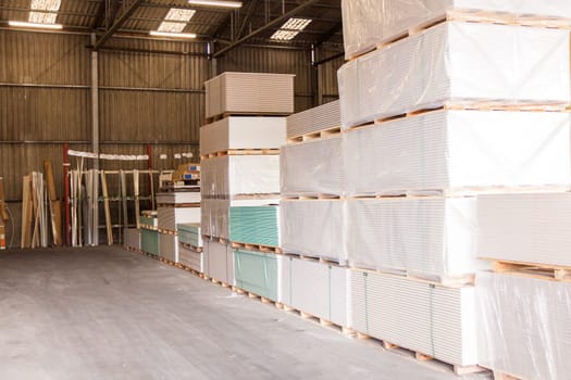 Drywall material in an outdoor warehouse on an industrial site