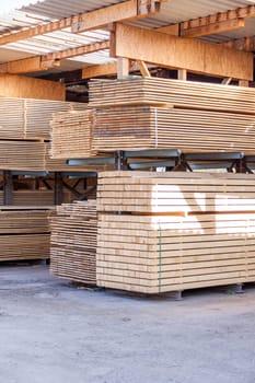 Wooden panels stacked in the warehouse for shipping or production for flooring