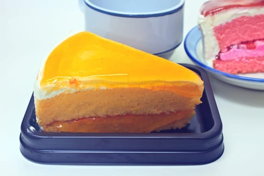Dessert Orange Cheesecake with Strawberry cheesecake in plate on background