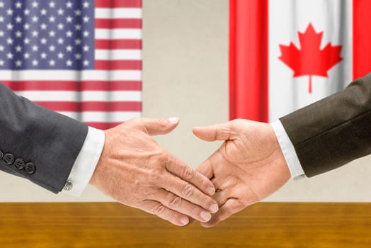U.S. and Canadian officials shake hands