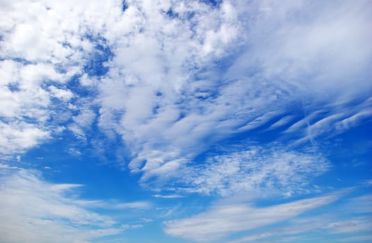 Blue sky background with a tiny clouds
