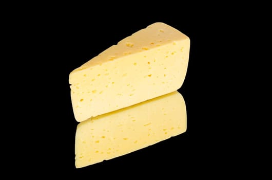 Piece of cheese  isolated on black