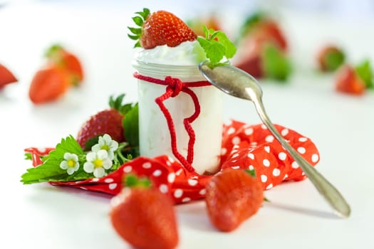 Fresh yoghurt with strawberries in a glass insulated on a white background