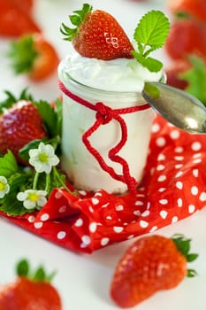 Fresh yoghurt with strawberries in a glass insulated on a white background