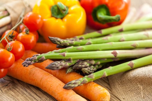 Fresh vegetables with tomatoes,peppers and asparagus as a close-up on an outdoor table
