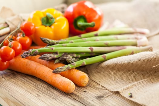 Fresh vegetables with tomatoes,peppers and asparagus as a close-up on an outdoor table