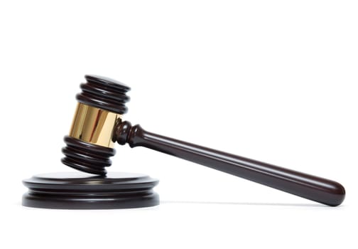 A wooden judge gavel and soundboard isolated on white background