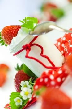 Fresh yoghurt with strawberries in a glass insulated on a white background