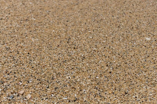 Sand gravel at the sea as a close-up as a background