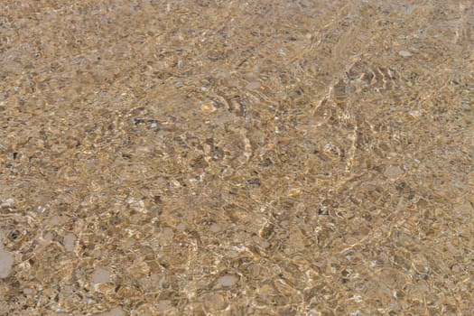 Sand gravel at the sea as a close-up as a background