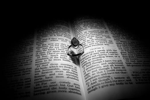 Wedding Ring and heart shaped shadow over a Bible