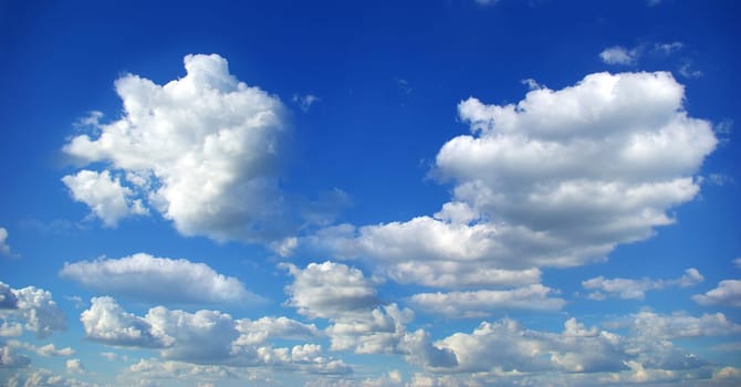 Blue sky background with tiny clouds