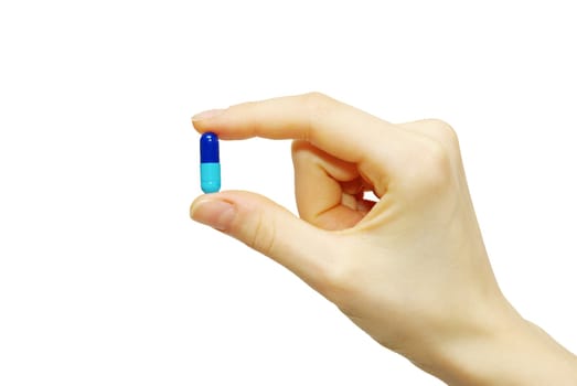 finger holds pill isolated on white