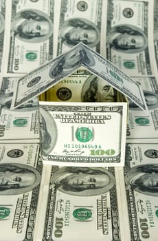 Money house on dollars background