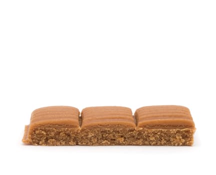 toffee in plate on white background