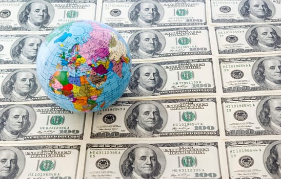 A globe and dollars is isolated on a whiteness