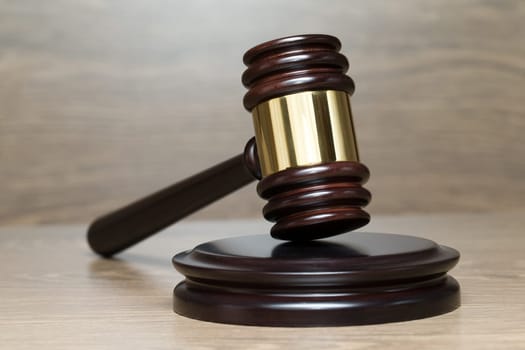 judge gavel on the brown wooden background..