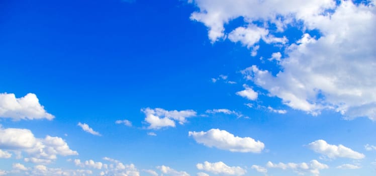 Blue sky background with tiny clouds
