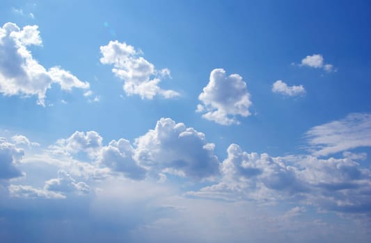 Blue sky background with tiny clouds