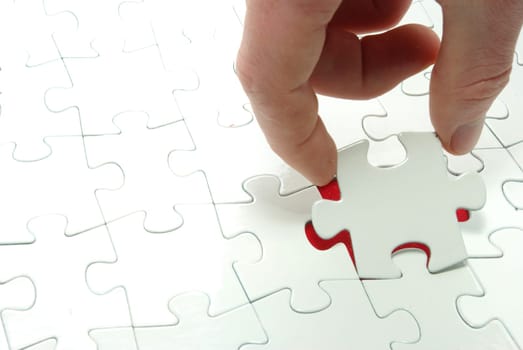 hands holding a puzzle piece . business concepts