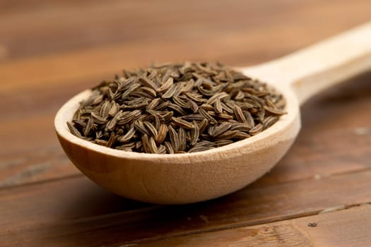 cumin seeds in wooden spoon