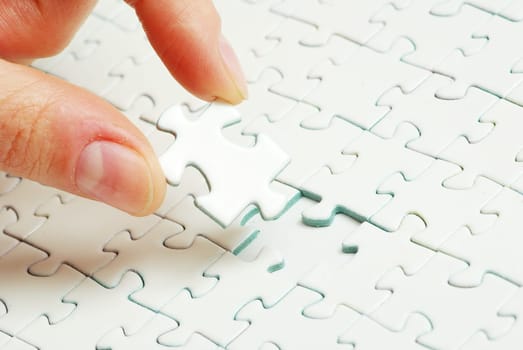 hands holding a puzzle piece . business concepts