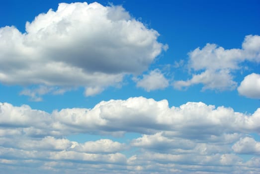 Blue sky background with tiny clouds
